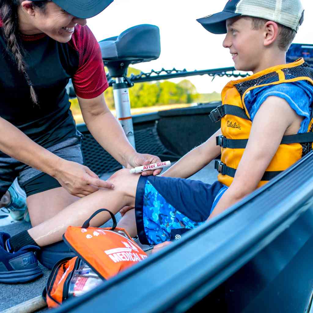 After Bite Advanced woman applying to child's leg while on a boat