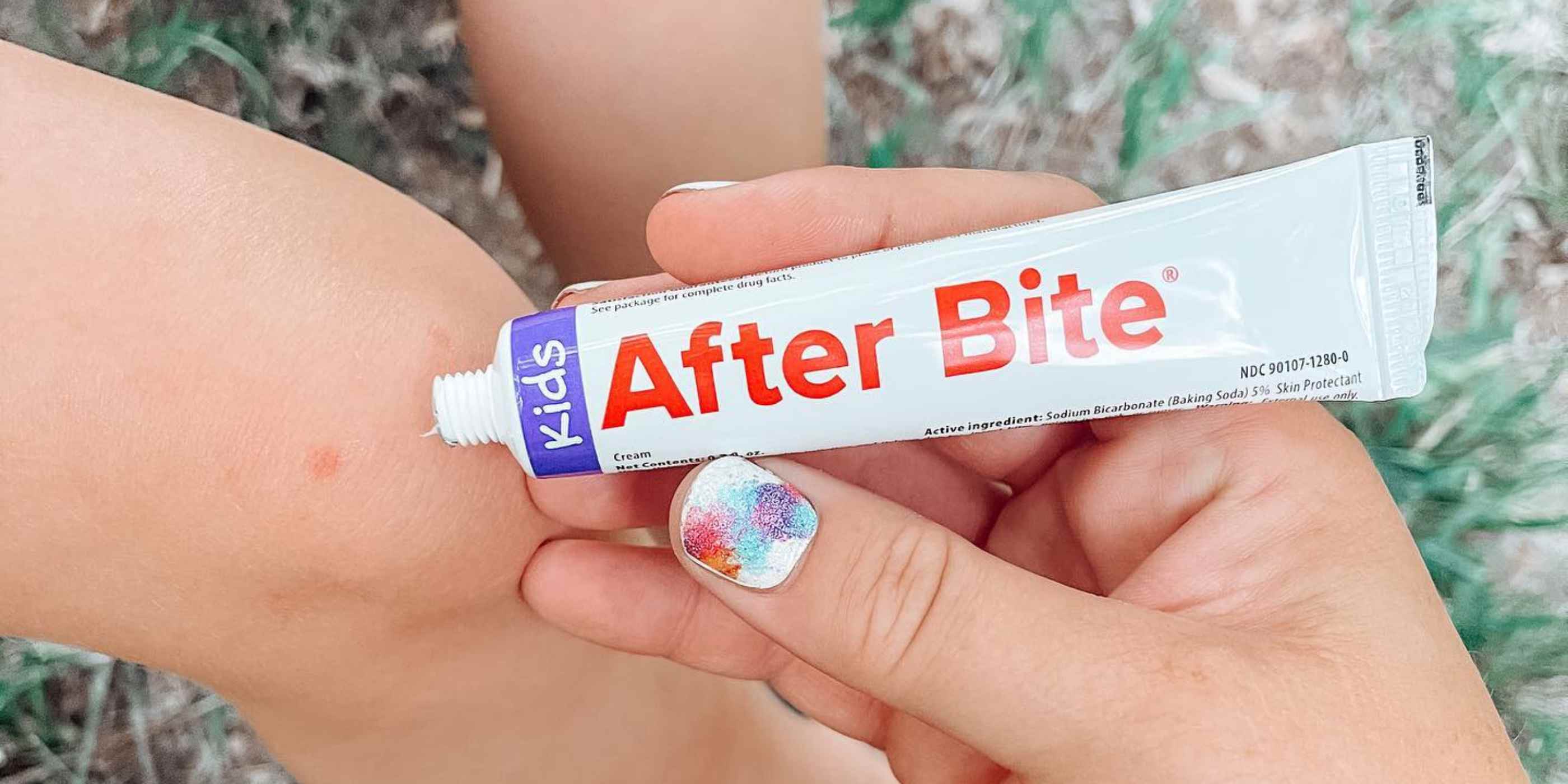 Mom applying After Bite Kids to child's leg