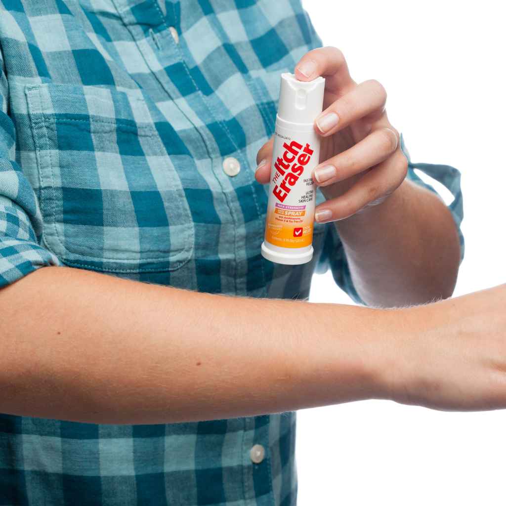 The Itch Eraser Spray person in blue plaid shirt spraying on arm