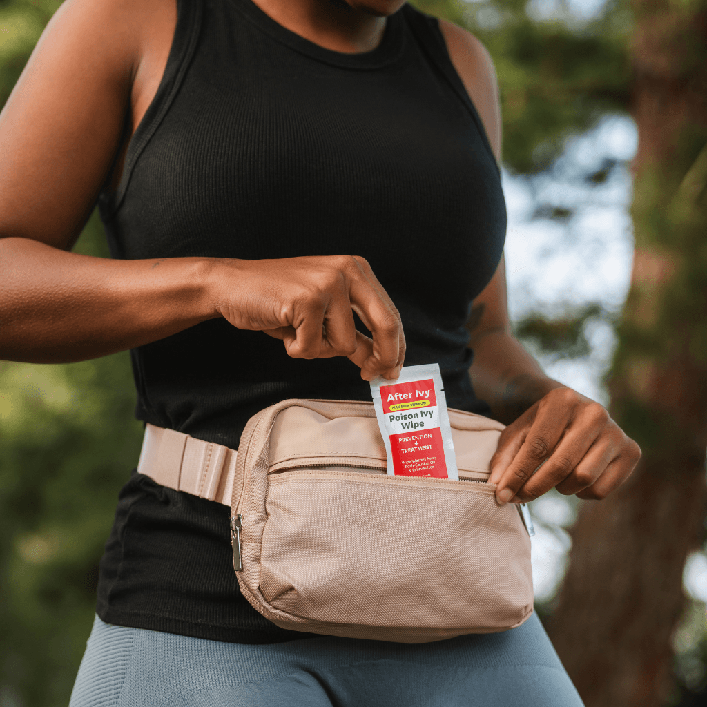 Woman storing an After Ivy packet in her fanny pack