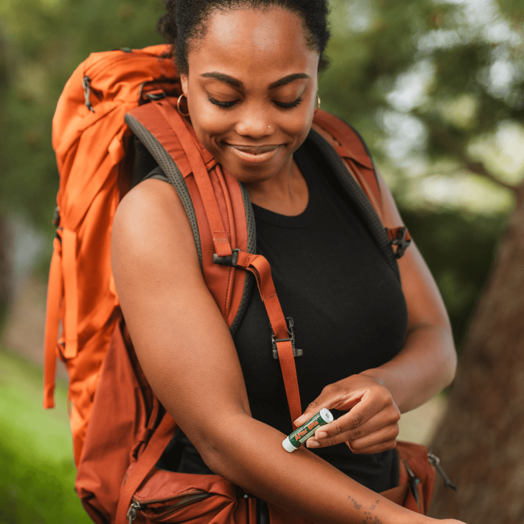 Hiker using the After Bite Natural stick on the trail
