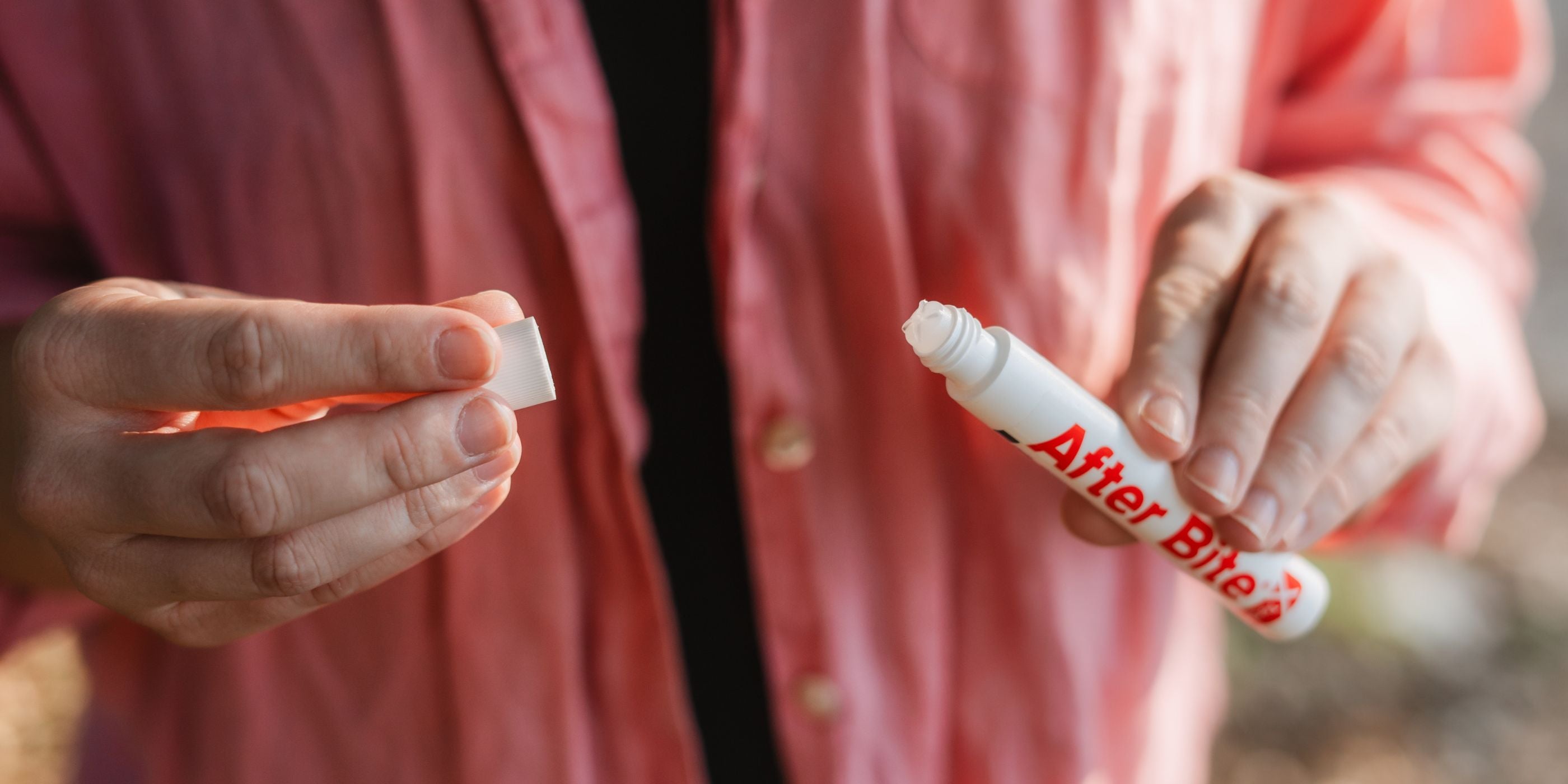 Woman removing cap from After Bite X-Tech