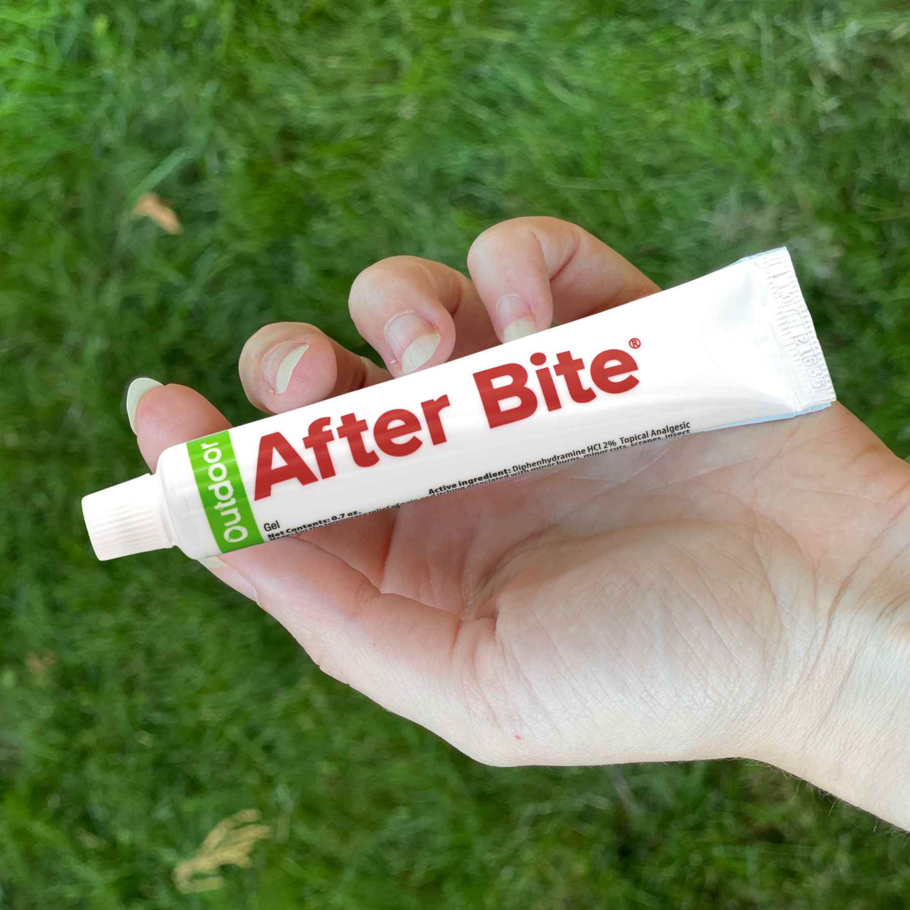 After Bite Outdoor in hand over grass