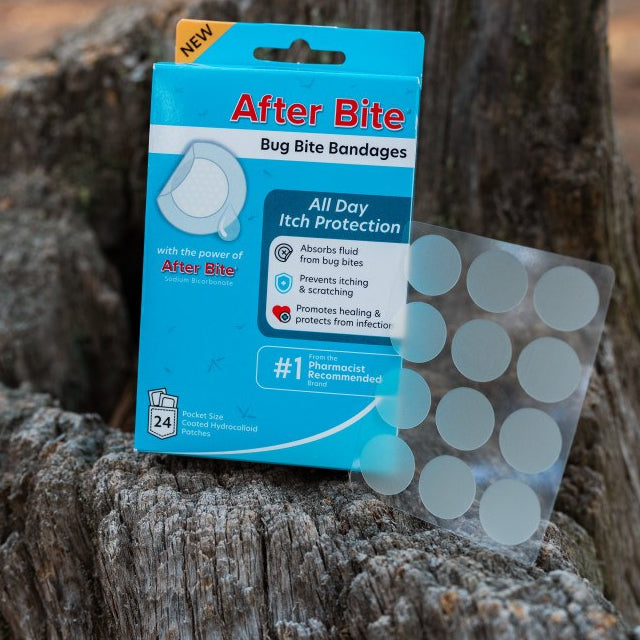 After Bite Bug Bite Bandages box and sheet of bandages on a tree stump 
